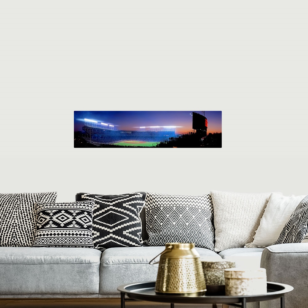 A bohemian room featuring Panoramic photograph of a packed baseball stadium at night.