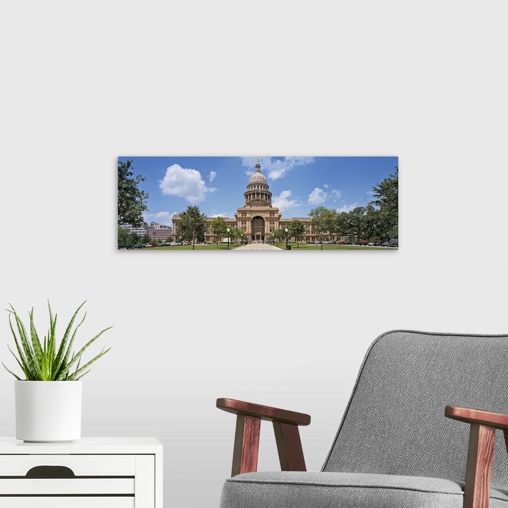 A modern room featuring The state capitol building in Texas is photographed in wide angle view showing the pathway and tr...