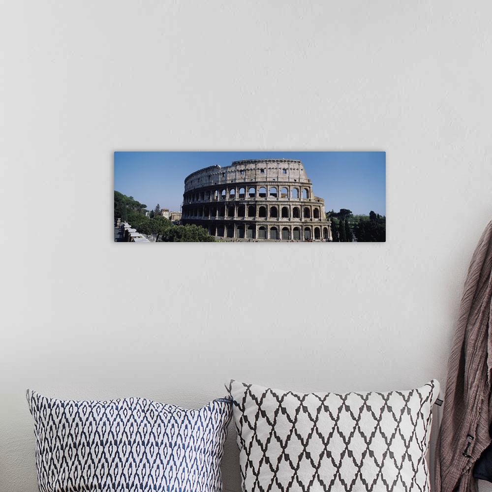 A bohemian room featuring Wide angle photograph taken of the famous coliseum in Rome.