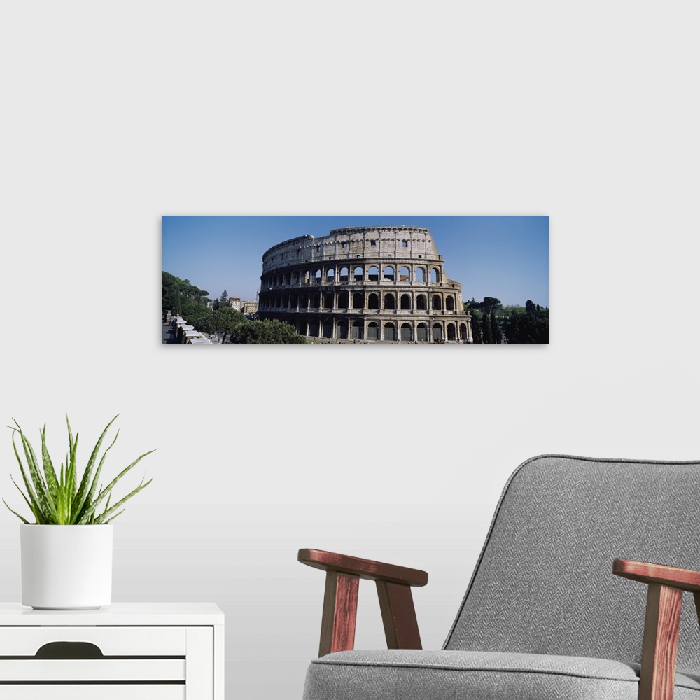 A modern room featuring Wide angle photograph taken of the famous coliseum in Rome.