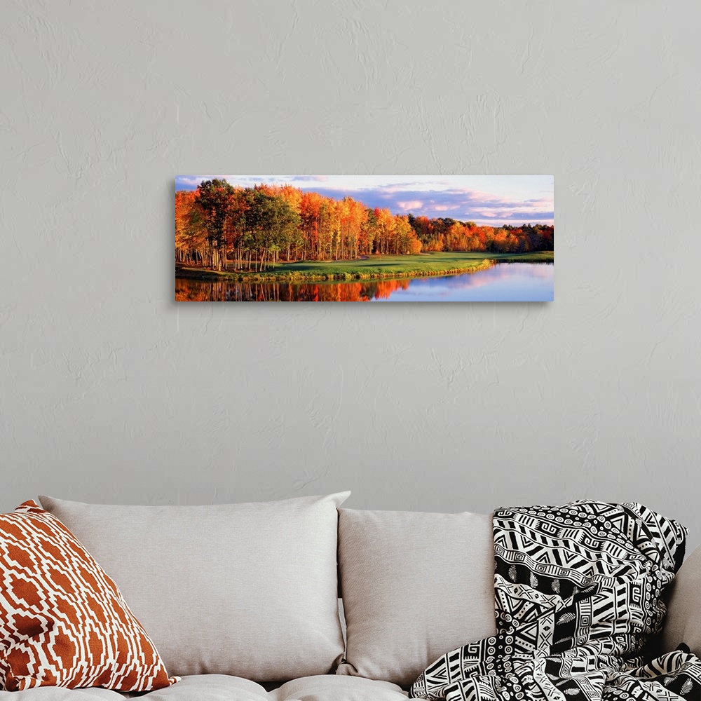 A bohemian room featuring Panoramic wall art, photograph of autumn trees reflecting in still waters.