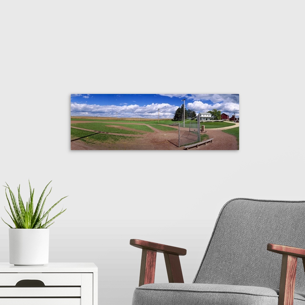 A modern room featuring Landscape, large photograph of a baseball diamond on a farm, beneath a vast blue sky in Dyersvill...