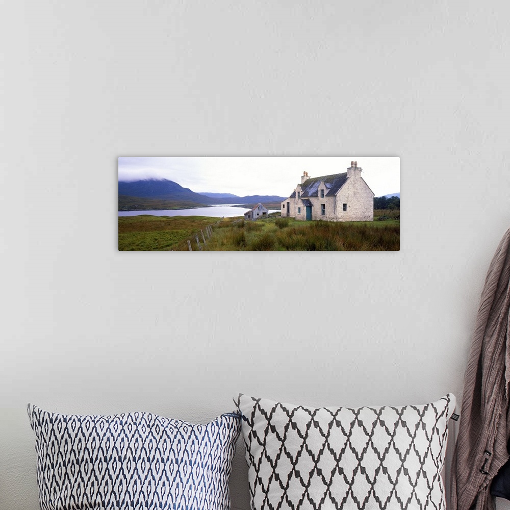 A bohemian room featuring Farm house on bluff, mountains in mist, Isle of Lewis, Scotland