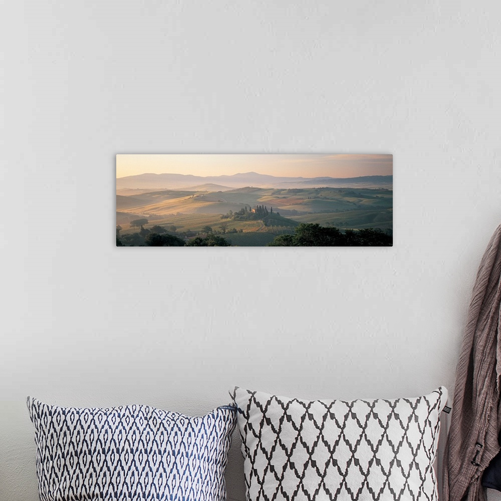 A bohemian room featuring The sun rises over the farmland and hills of the mist covered country side in this panoramic phot...