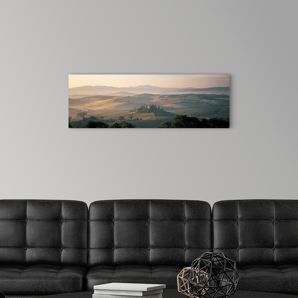 A modern room featuring The sun rises over the farmland and hills of the mist covered country side in this panoramic phot...