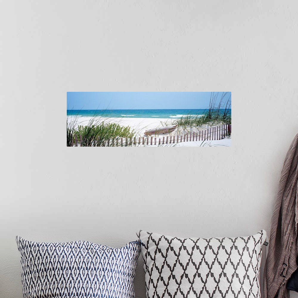 A bohemian room featuring Panoramic landscape photograph of a fence buried in the dunes on sandy beach on the Gulf Coast.