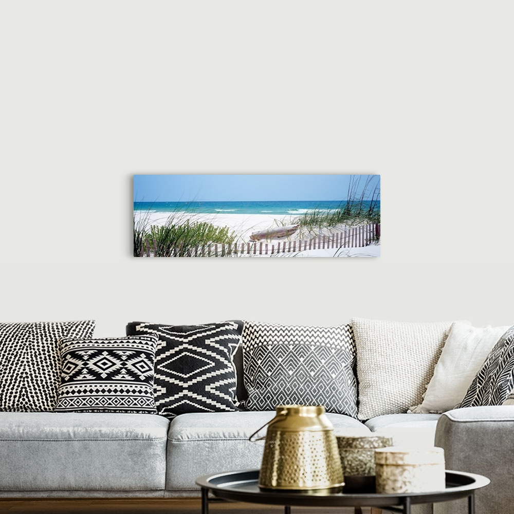 A bohemian room featuring Panoramic landscape photograph of a fence buried in the dunes on sandy beach on the Gulf Coast.