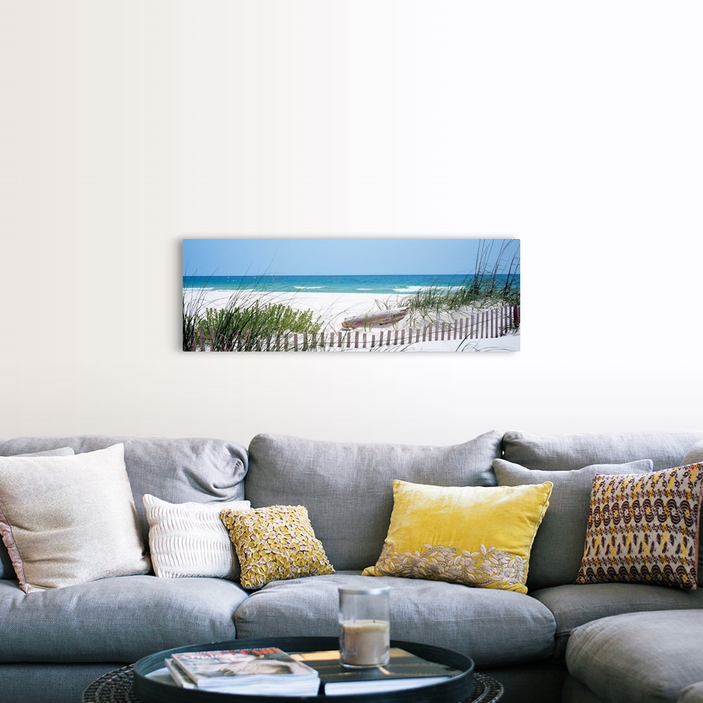 A farmhouse room featuring Panoramic landscape photograph of a fence buried in the dunes on sandy beach on the Gulf Coast.