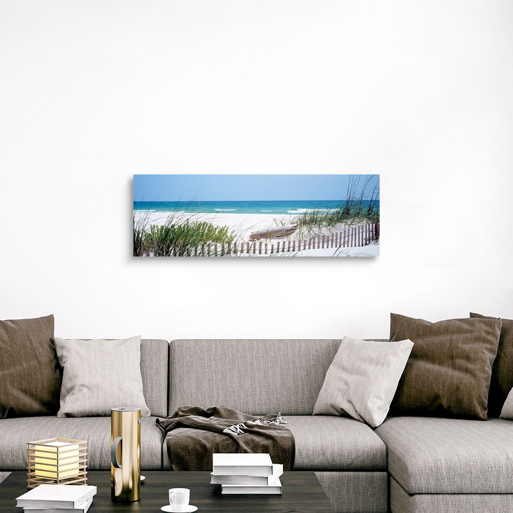 A traditional room featuring Panoramic landscape photograph of a fence buried in the dunes on sandy beach on the Gulf Coast.