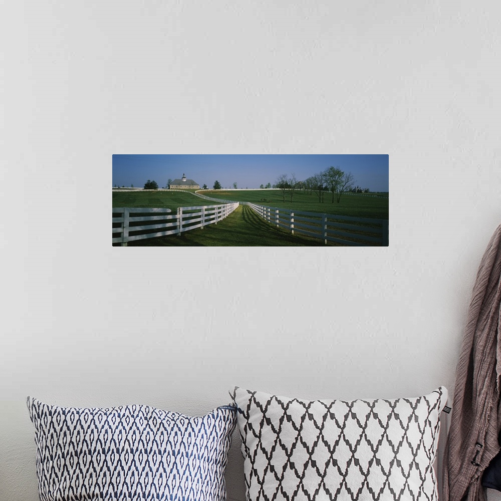 A bohemian room featuring Panoramic photograph of fenced pasture with house in the distance.