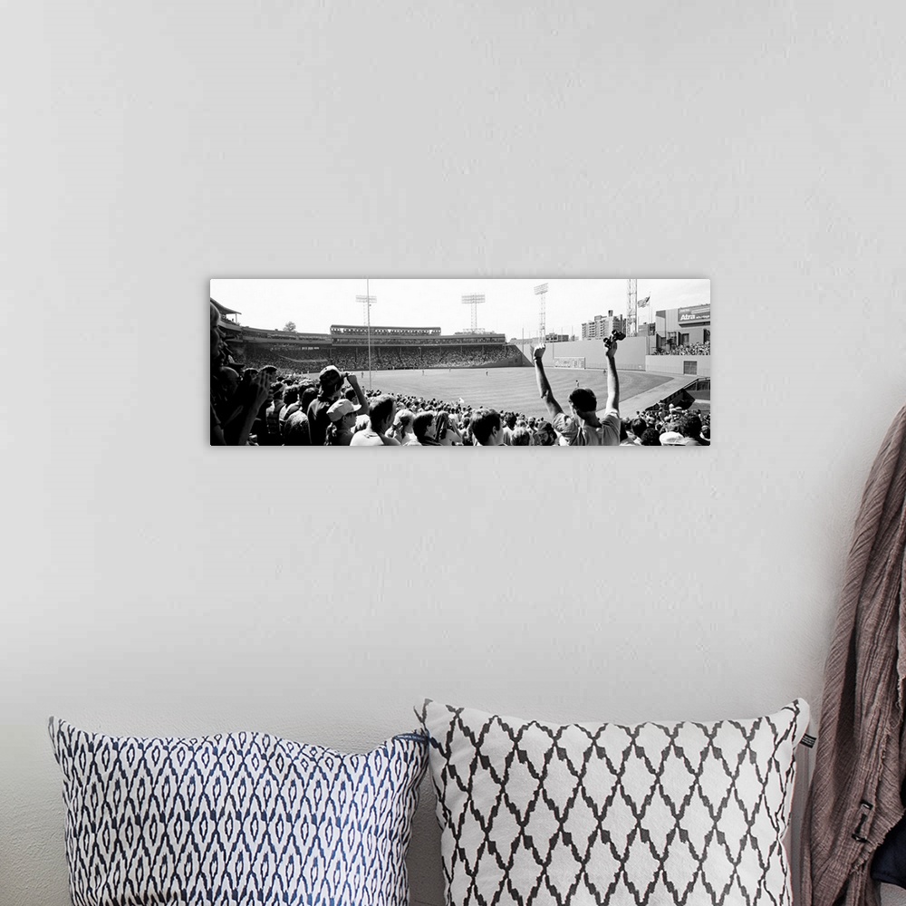 A bohemian room featuring Big, panoramic black and white photograph of Fenway Park in Boston, with fans standing and cheeri...