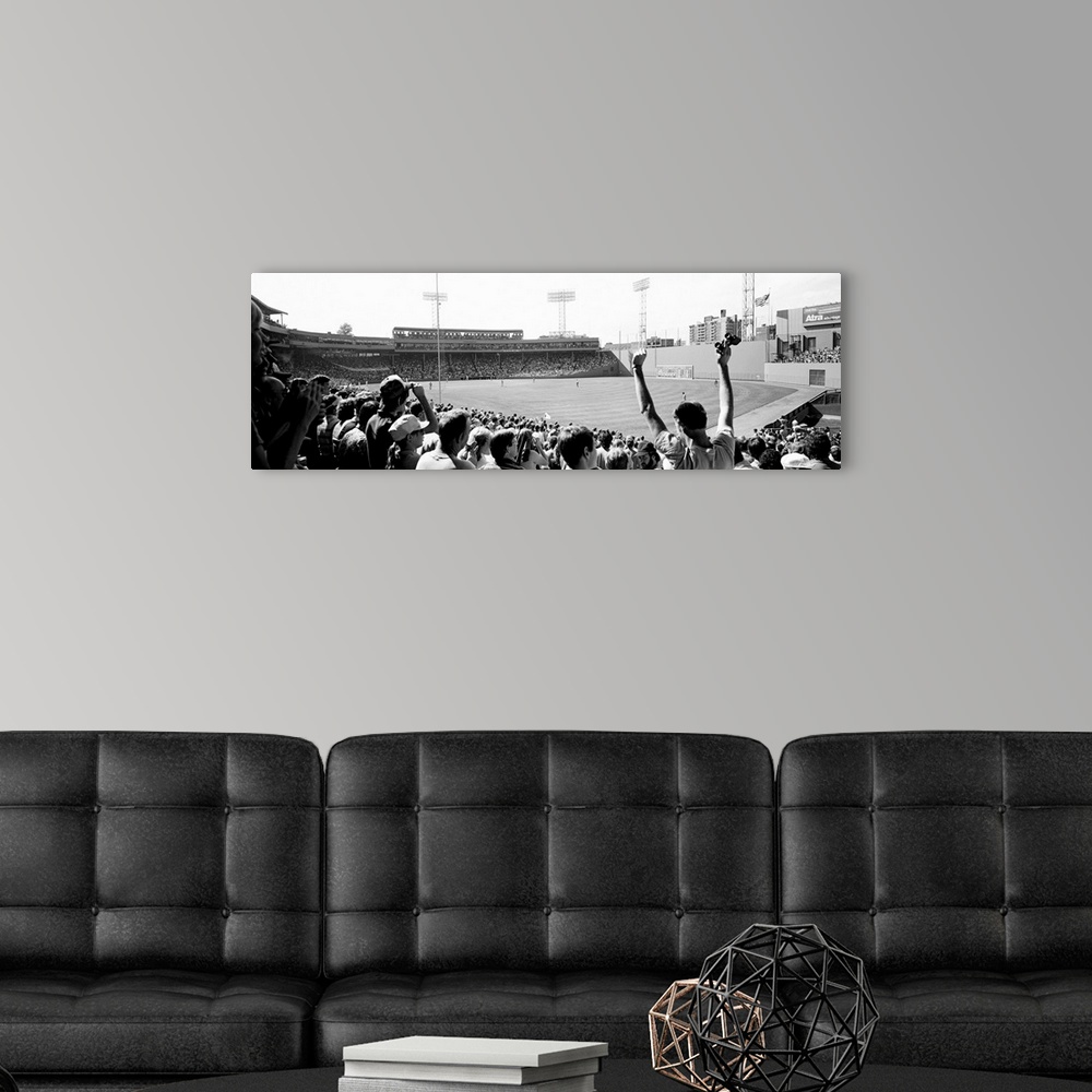 A modern room featuring Big, panoramic black and white photograph of Fenway Park in Boston, with fans standing and cheeri...