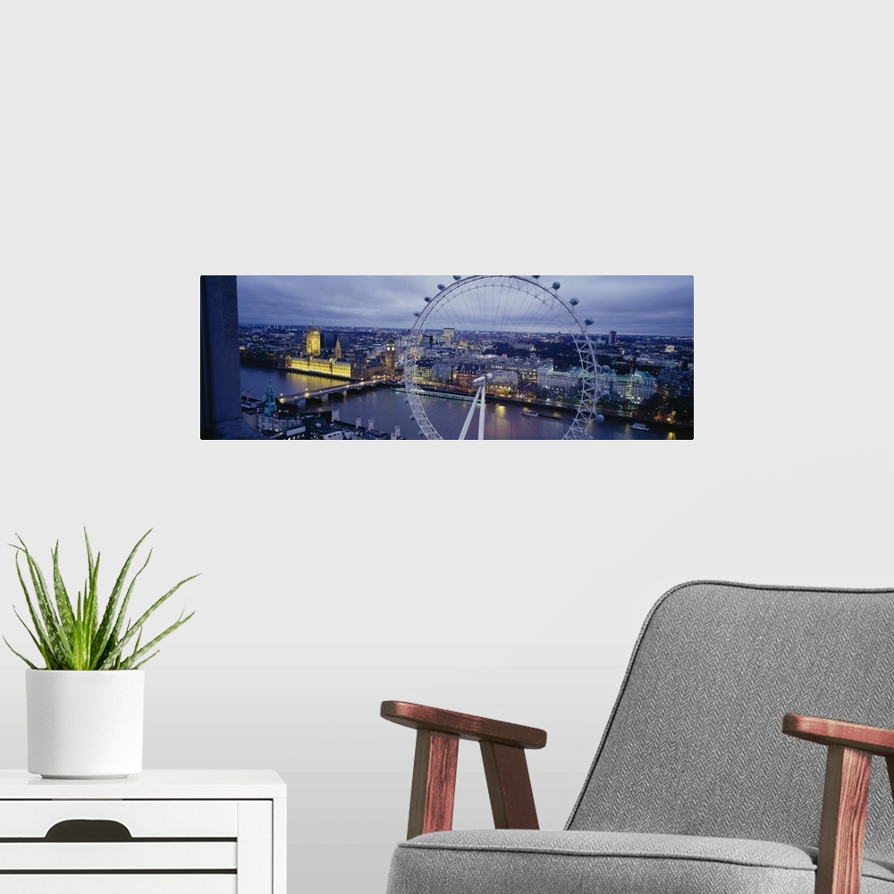 A modern room featuring This is a city scape panoramic that showcases several city landmarks in the twilight.