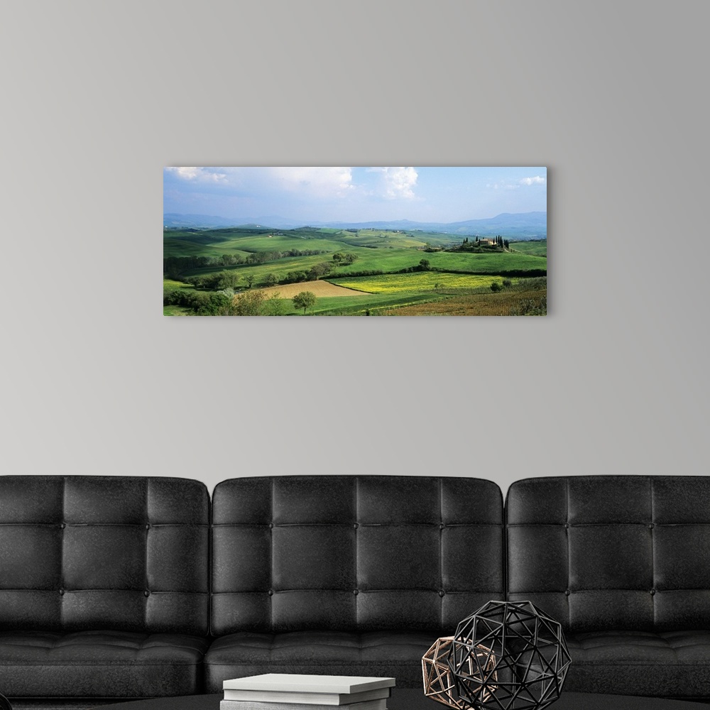 A modern room featuring Vast land and large green fields in Italy are pictured in a wide angle view.