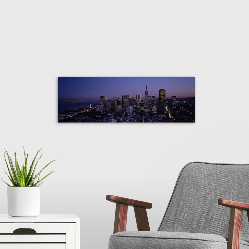 A modern room featuring Aerial photograph taken of the San Francisco skyline illuminated under a night sky.