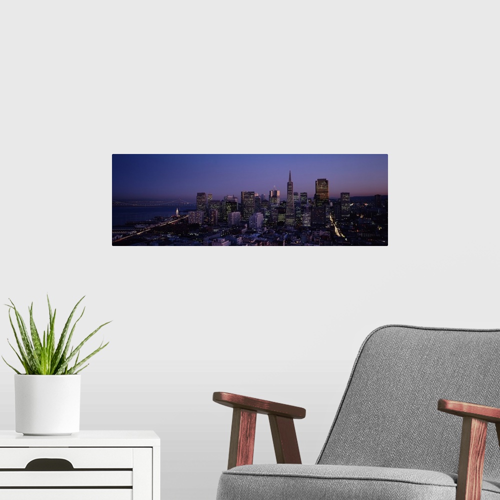 A modern room featuring Aerial photograph taken of the San Francisco skyline illuminated under a night sky.