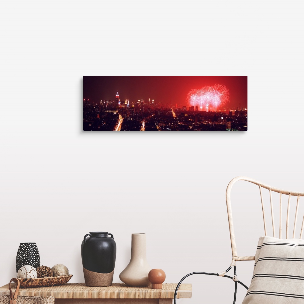 A farmhouse room featuring This glowing panoramic wall art captures the burst of three rockets over the water as well as sev...