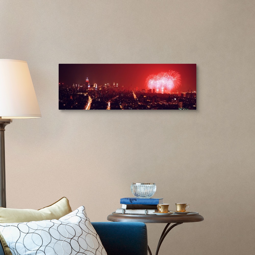 A traditional room featuring This glowing panoramic wall art captures the burst of three rockets over the water as well as sev...