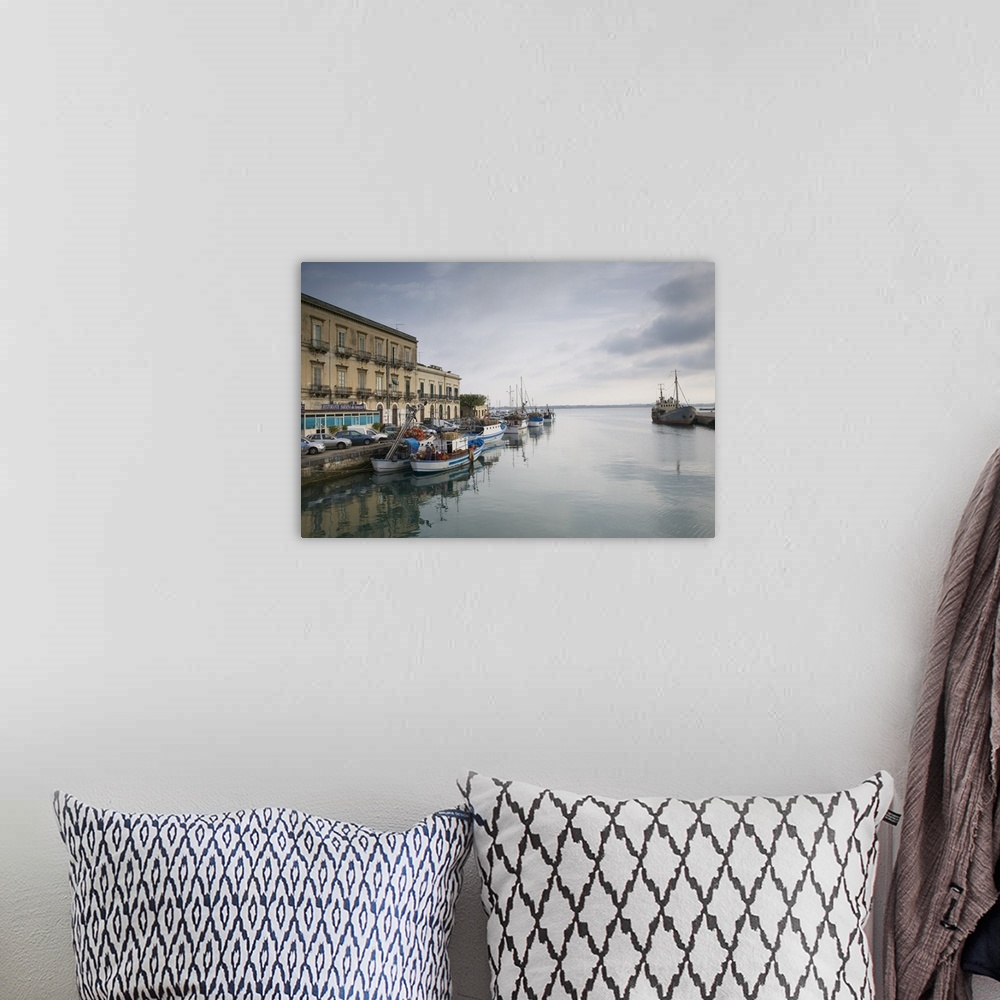 A bohemian room featuring Fishing boats docked at a harbor, Ortygia, Siracusa, Sicily, Italy