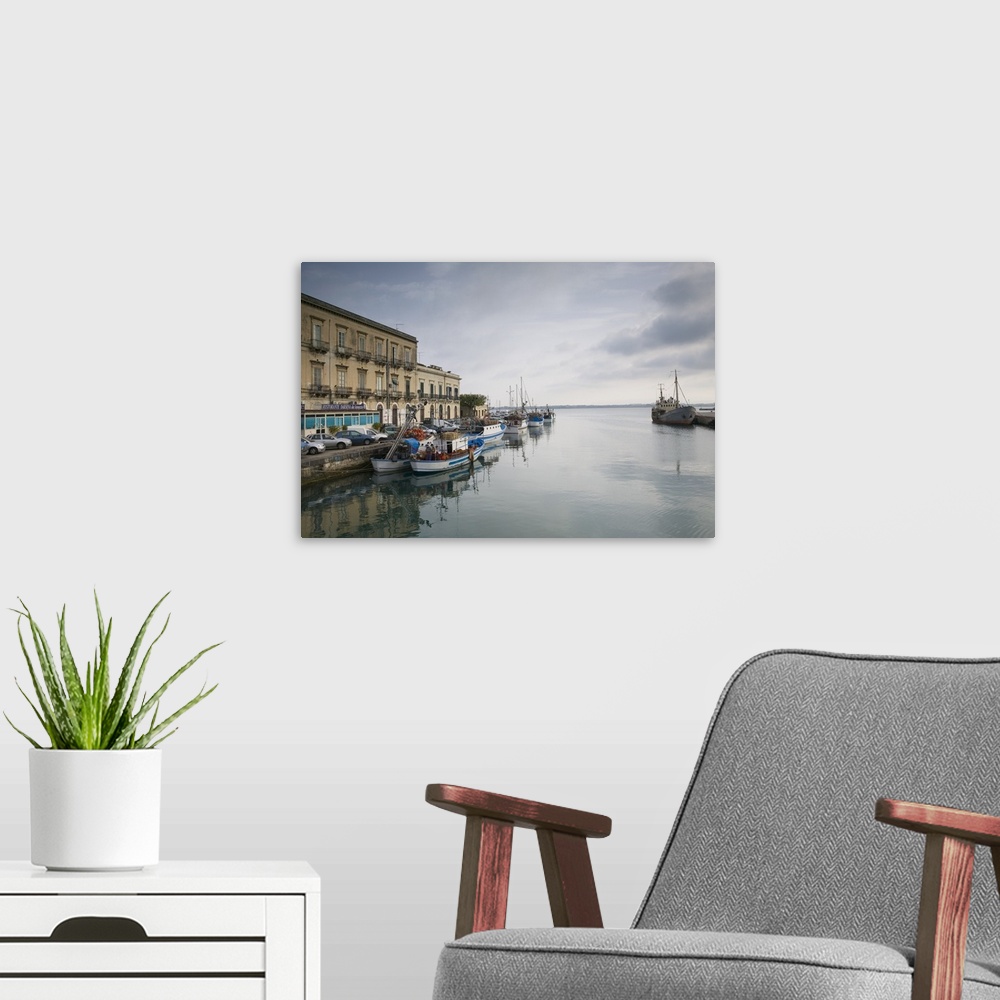 A modern room featuring Fishing boats docked at a harbor, Ortygia, Siracusa, Sicily, Italy