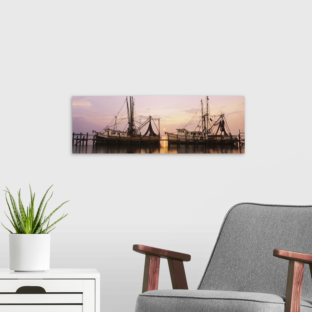A modern room featuring Wide angle photograph of two large fishing boats anchored alongside a dock in the Amelia River, a...