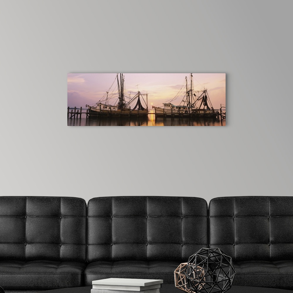 A modern room featuring Wide angle photograph of two large fishing boats anchored alongside a dock in the Amelia River, a...