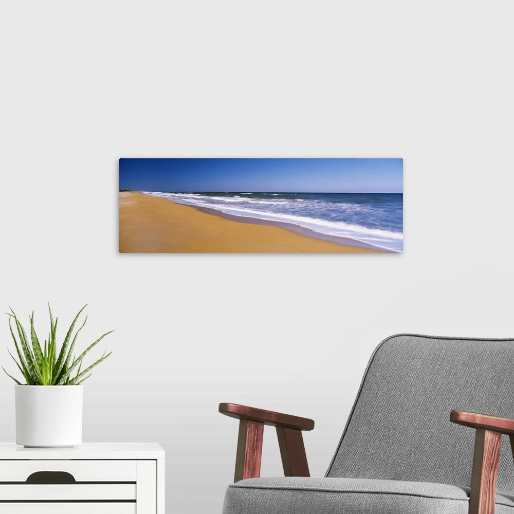 A modern room featuring Wide angle photograph of the shoreline of Flagler Beach, the waves of the Atlantic Ocean crashing...