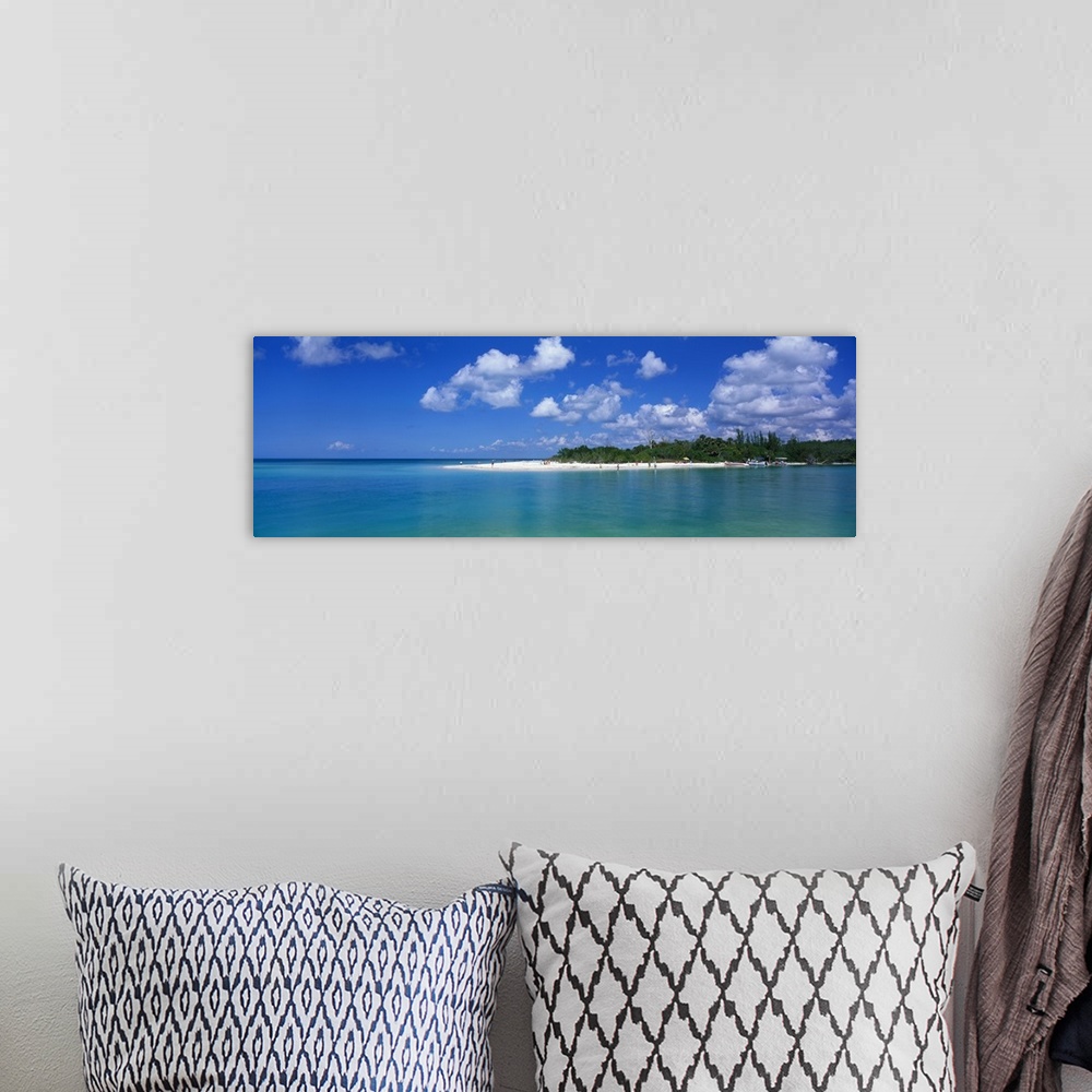 A bohemian room featuring Large panoramic photograph of a small beach off the coast in Florida with teal colored water surr...