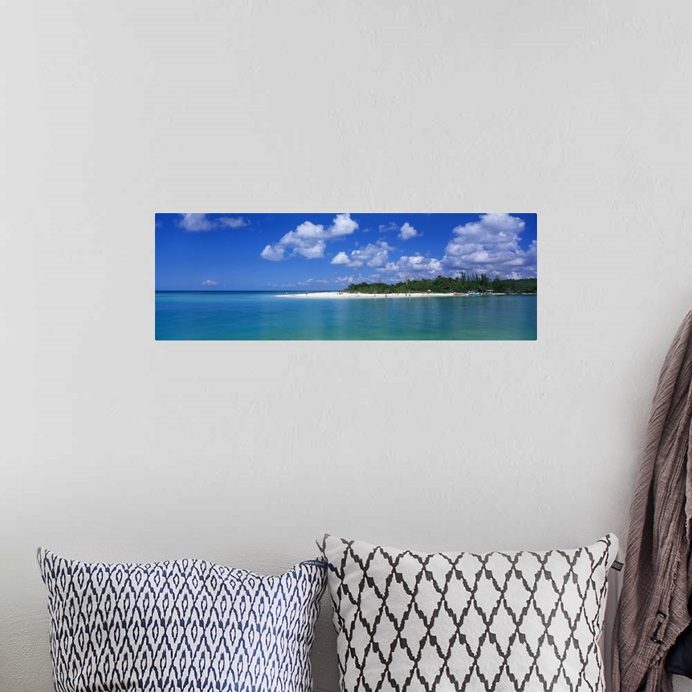 A bohemian room featuring Large panoramic photograph of a small beach off the coast in Florida with teal colored water surr...