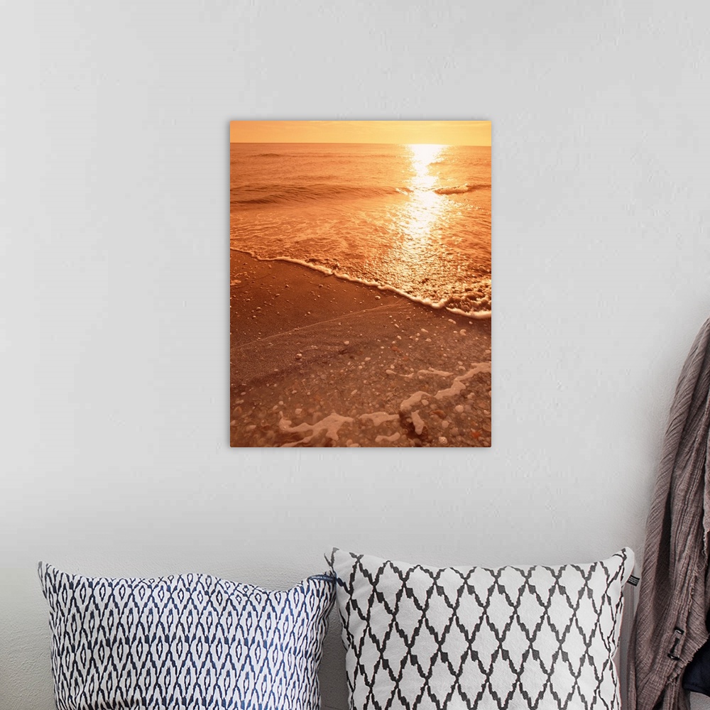 A bohemian room featuring Vertical photograph on a big canvas water rushing onto the shore of Sanibel Beach, Florida in the...
