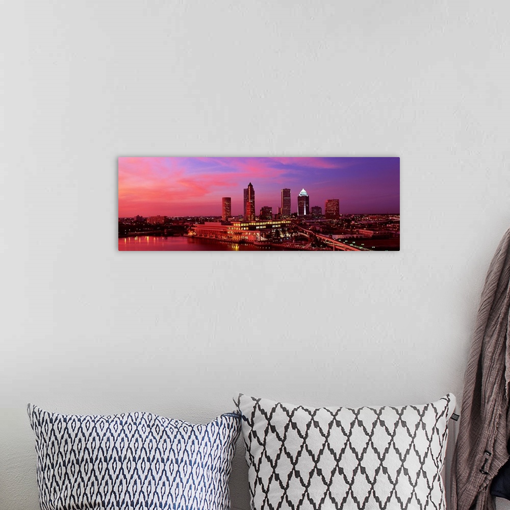 A bohemian room featuring This is a panoramic photograph of the city as the sunsets out of frame.
