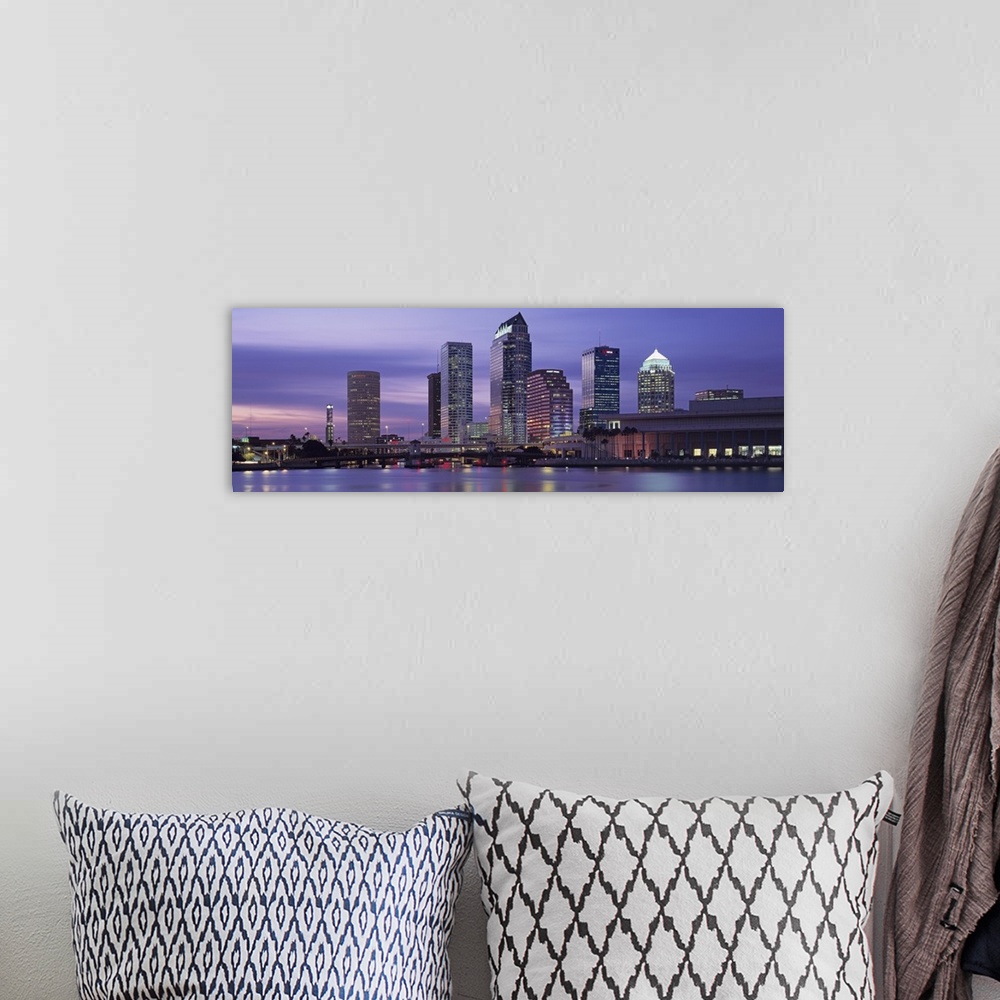 A bohemian room featuring Panoramic photograph taken at nighttime of a group of skyscrapers within a busy city in the South...