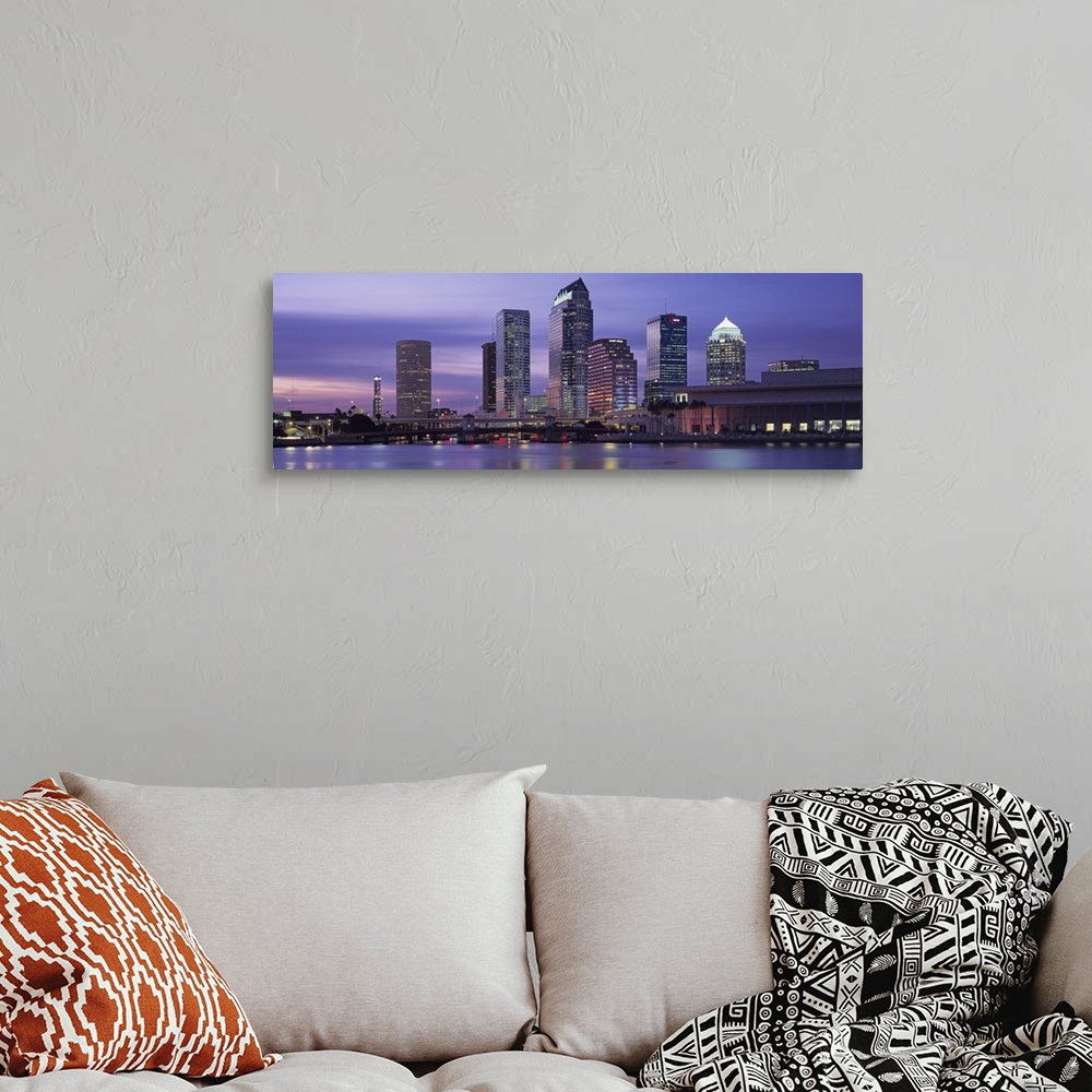 A bohemian room featuring Panoramic photograph taken at nighttime of a group of skyscrapers within a busy city in the South...