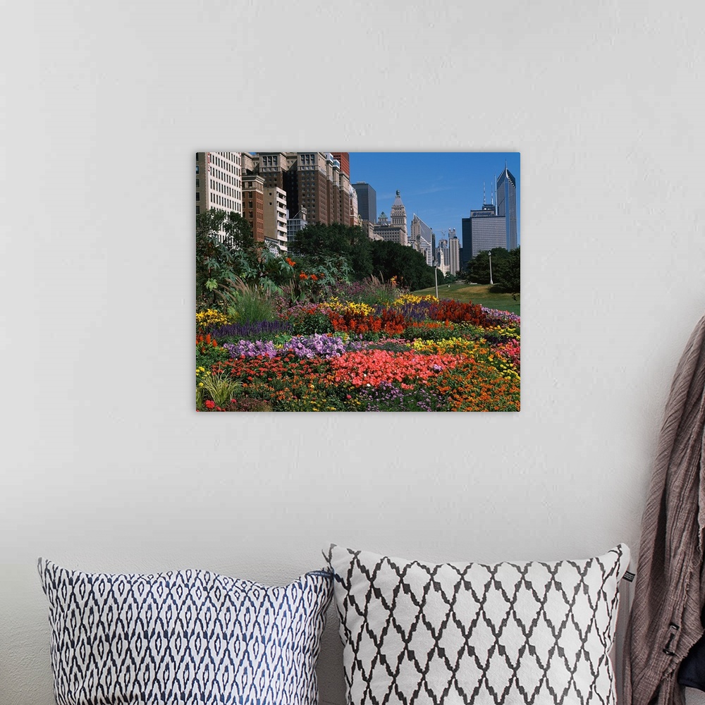 A bohemian room featuring A variety of flowers are photographed closely with a city skyline in the background.