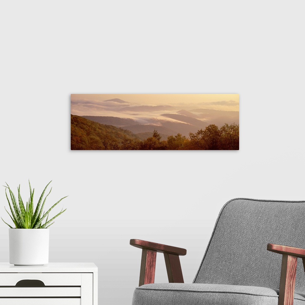 A modern room featuring View from the Blue Ridge Parkway of a foggy sunrise over a mountain range in North Carolina.