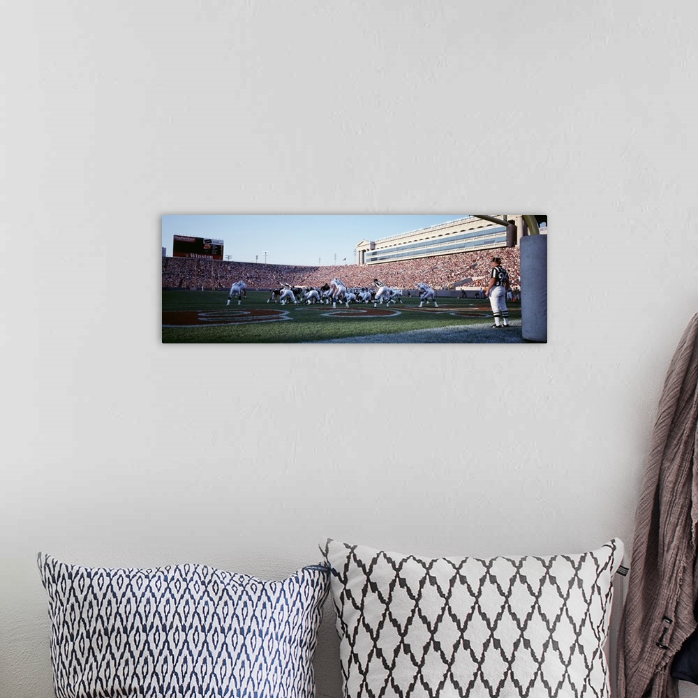 A bohemian room featuring Panoramic picture taken of the Chicago bears on the field at the scrimmage line with the stadium ...