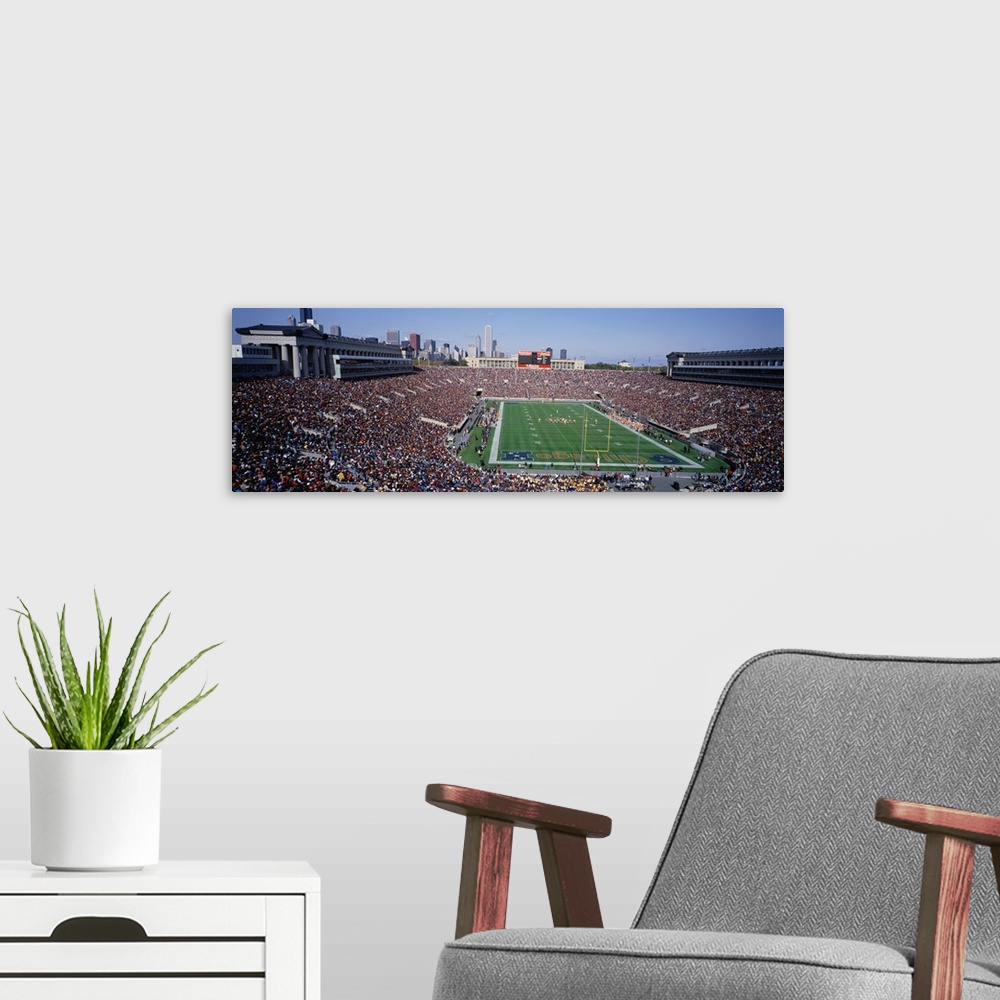 A modern room featuring Panoramic photograph of NFL stadium with the city's skyline in  the distance under clear skies.  ...