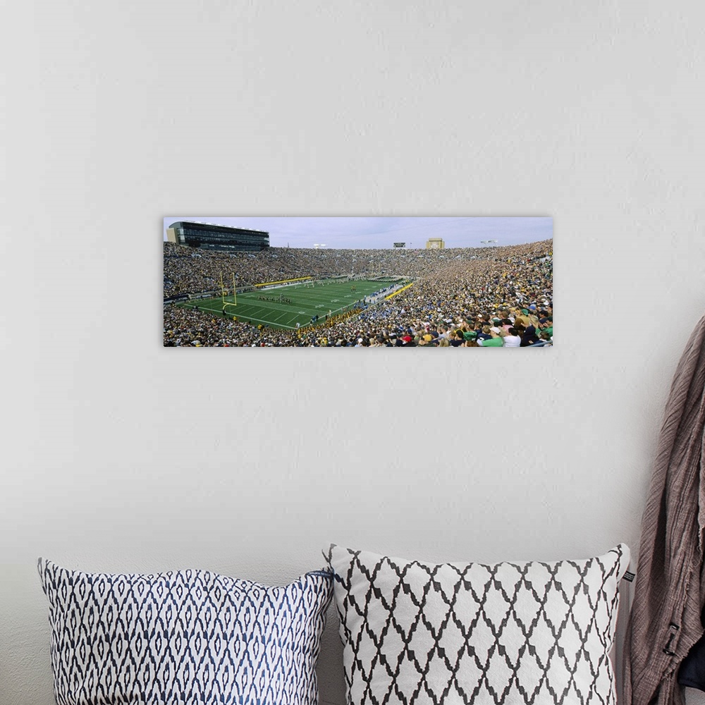 A bohemian room featuring Wide angle photograph of Notre Dame Stadium, full of fans during a football game, in South Bend, ...