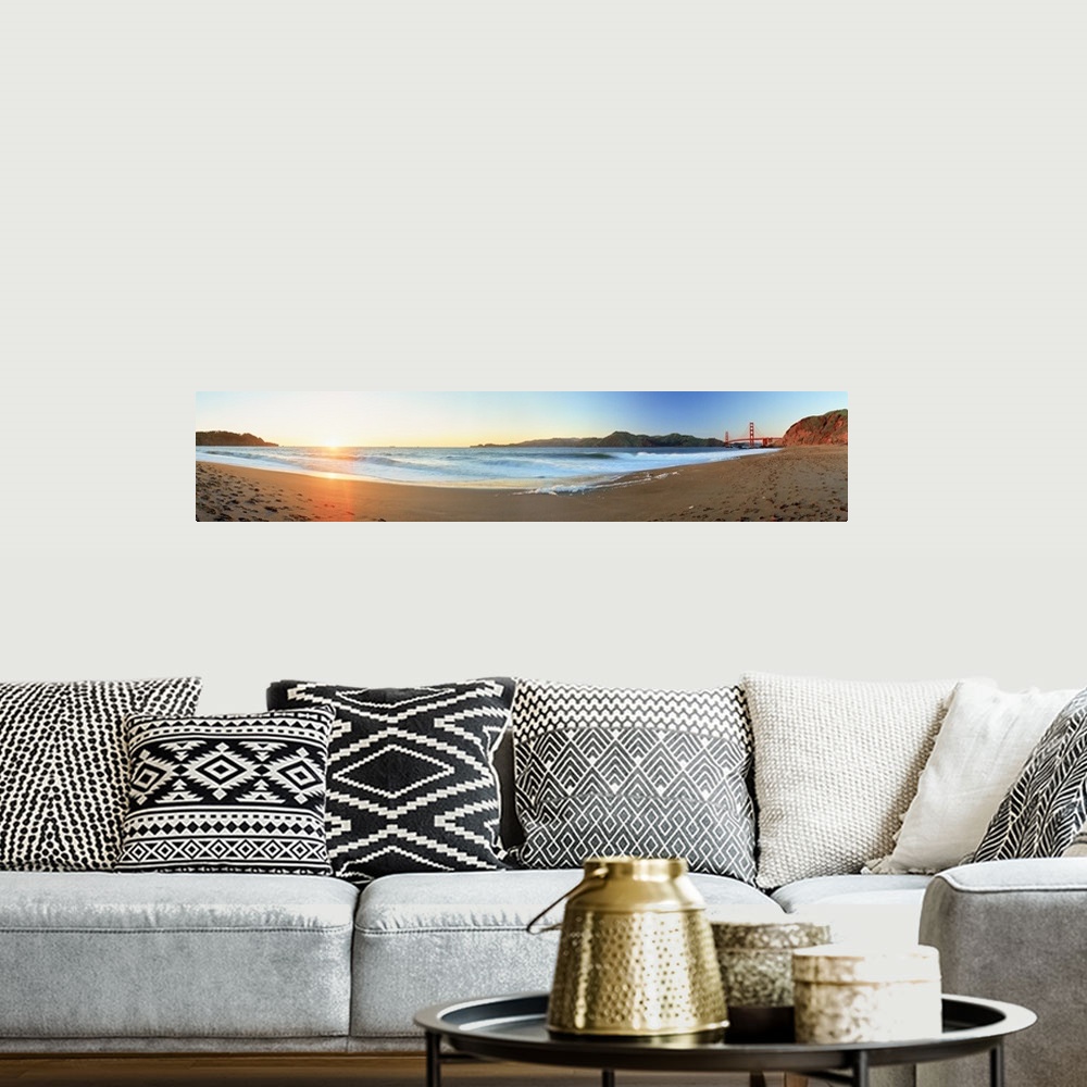 A bohemian room featuring Long panoramic photo of a beach with the golden gate bride on the far right and the setting sun o...