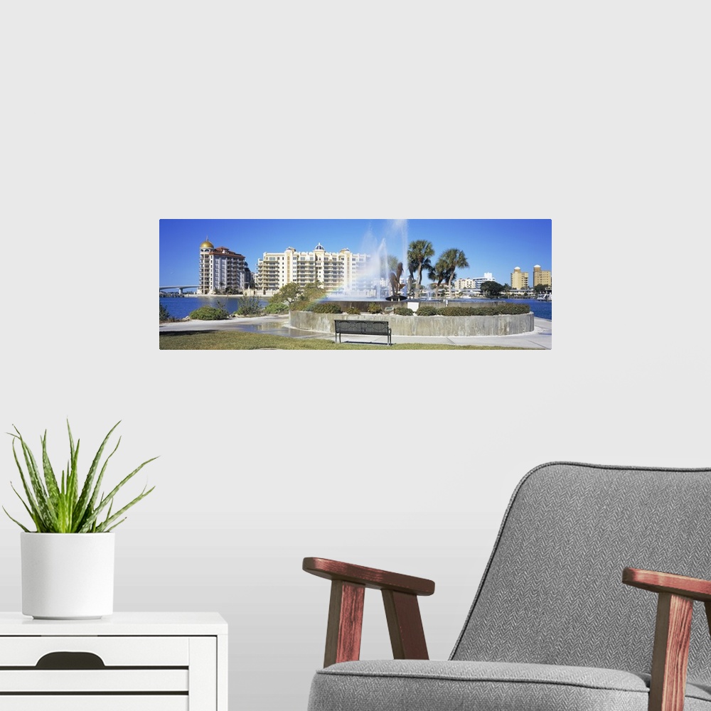 A modern room featuring Fountain in a park with building in the background, Golden Gate Point, Bayfront Park, Sarasota Ba...