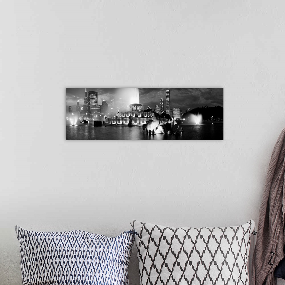 A bohemian room featuring A panoramic photograph of the Chicago Skyline highlighting a large fountain in black and white.
