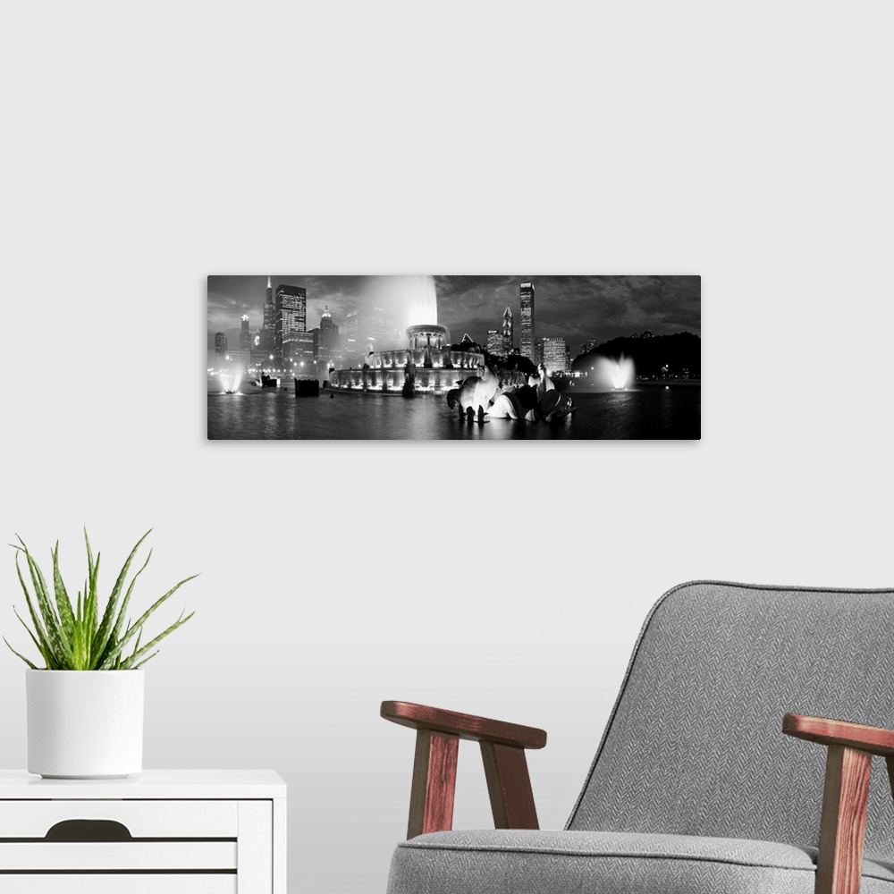A modern room featuring A panoramic photograph of the Chicago Skyline highlighting a large fountain in black and white.