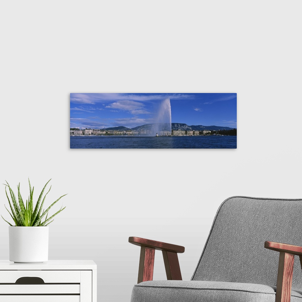 A modern room featuring Fountain in front of buildings, Jet Deau, Geneva, Switzerland