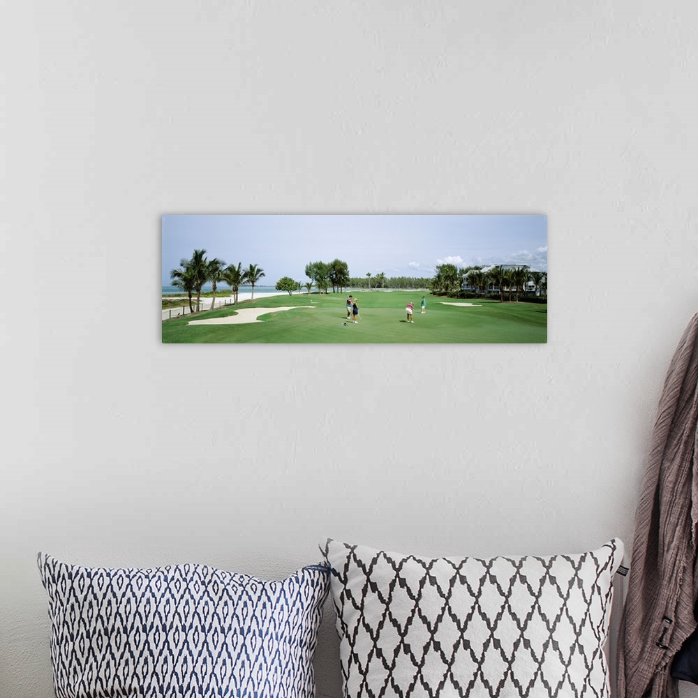 A bohemian room featuring Four people playing golf, South Seas Plantation, Captiva Island, Florida
