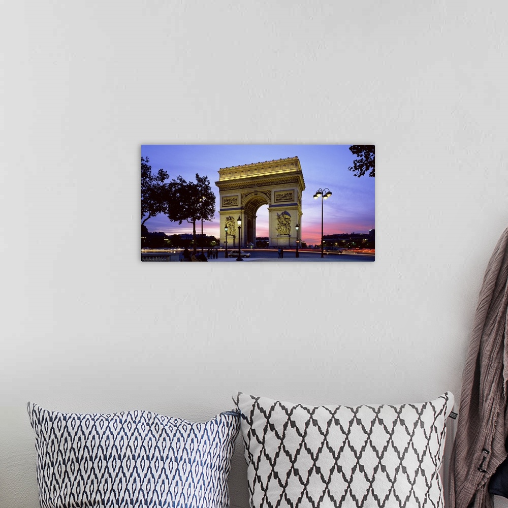 A bohemian room featuring Panoramic photo on canvas of a monument in Paris at dusk.