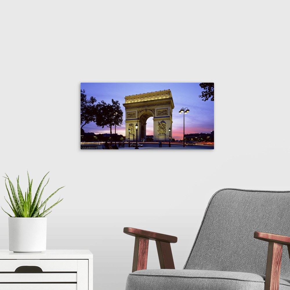 A modern room featuring Panoramic photo on canvas of a monument in Paris at dusk.