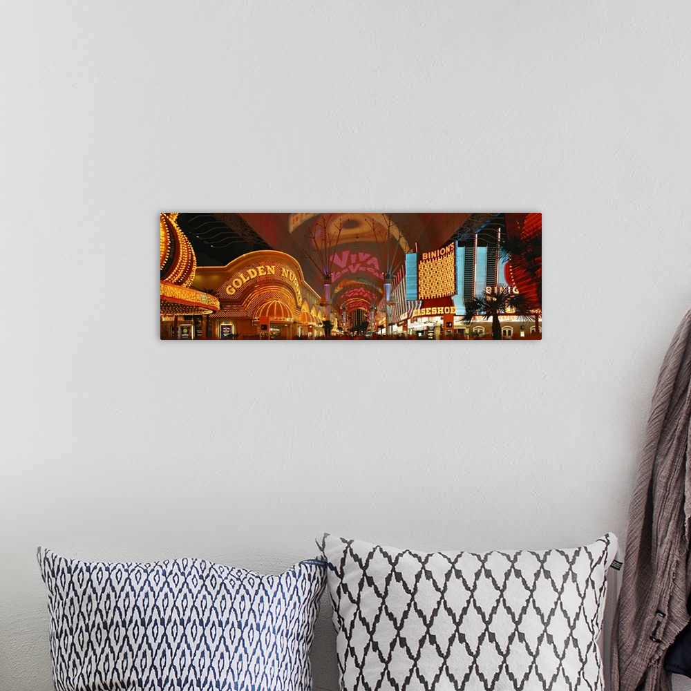 A bohemian room featuring This panoramic wall art is a photograph of the neon glitz and shine of the cityos casinos.