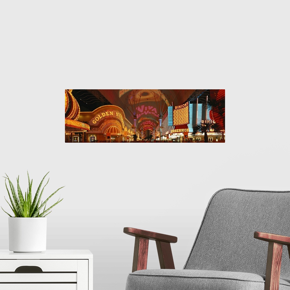 A modern room featuring This panoramic wall art is a photograph of the neon glitz and shine of the cityos casinos.