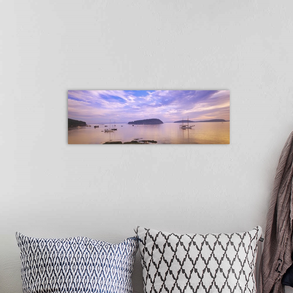 A bohemian room featuring Landscape photograph of numerous small boats in Frenchman Bay beneath a vibrant sky of wispy clou...