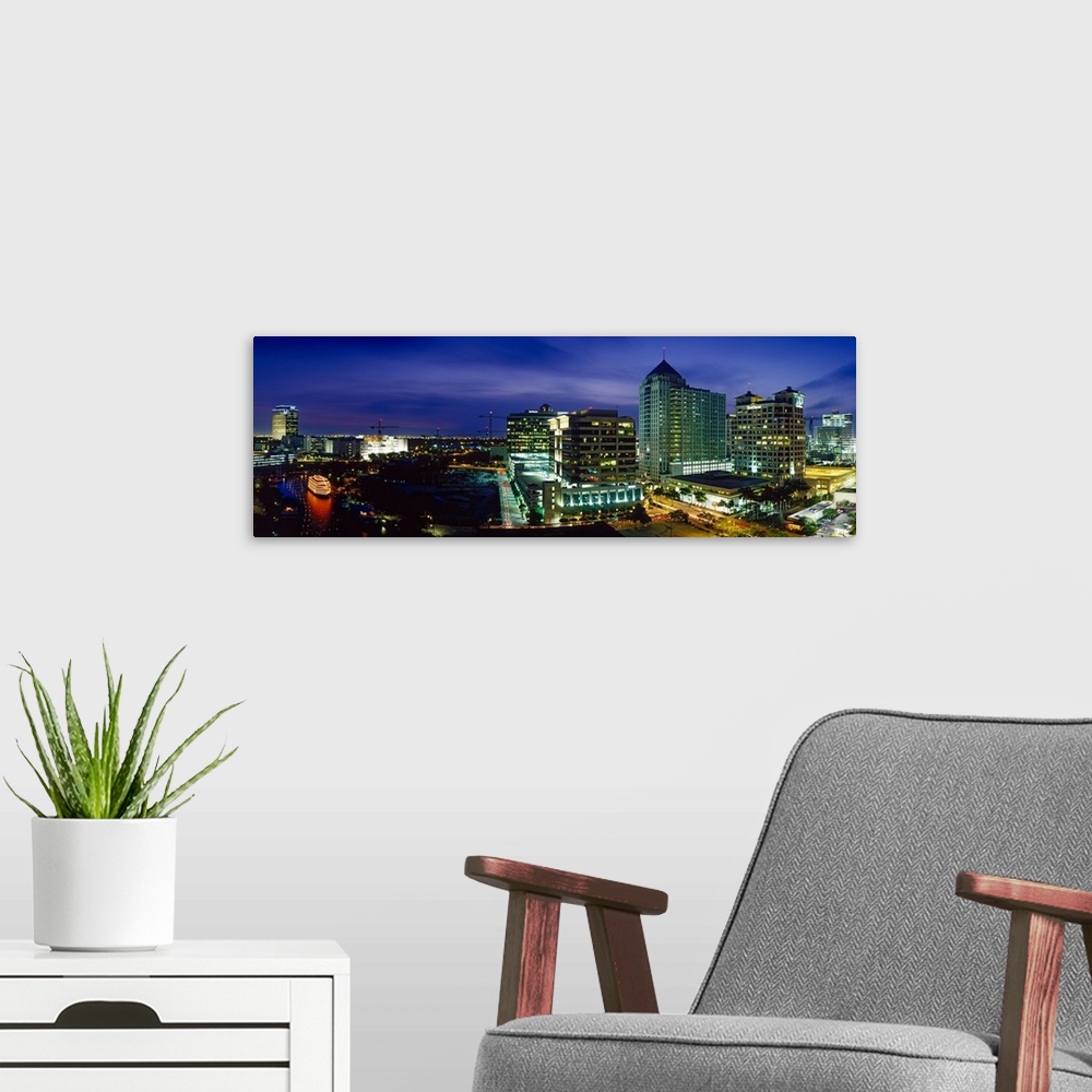 A modern room featuring Parts of the city of Ft. Lauderdale are illuminated under a night sky and shown in panoramic view.
